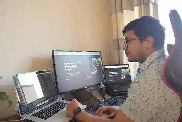 A man working on laptop and pointing to screen